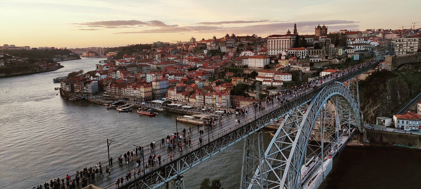 The bridge and the hillside city above the Douro at sunset.